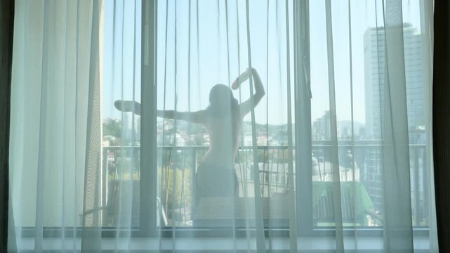 Long haired man dance on apartments balcony with flat shoes in hands, silly funny guy feel high spirits and shake body and hands in frolic, when nobody watching.