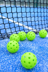 Lime Green Pickleball Balls on Blue Court Surface The Concept of Pickleball Game