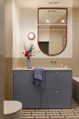 Stylish blue bathroom cabinet with flowers and mirror