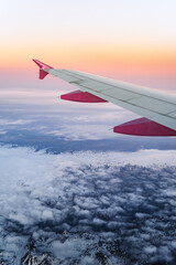 Fototapeta premium Flying over Iceland during sunrise. A view of Iceland from an airplane window with glaciers and snowy mountains
