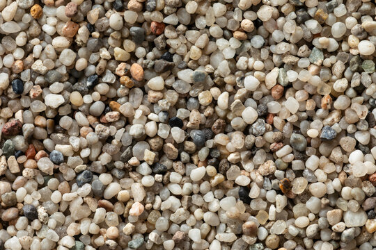 Close-up of small, fine pea gravel seen from above - studio shot. Background texture for use in another project.