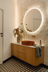 Elegant Bathroom with Round Illuminated Mirror and Vanity