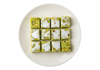 pistachio dessert squares on white plate in a neat green grid