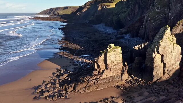 Morning light on Sandymouth Bay  large rocks at low tide Cornwall