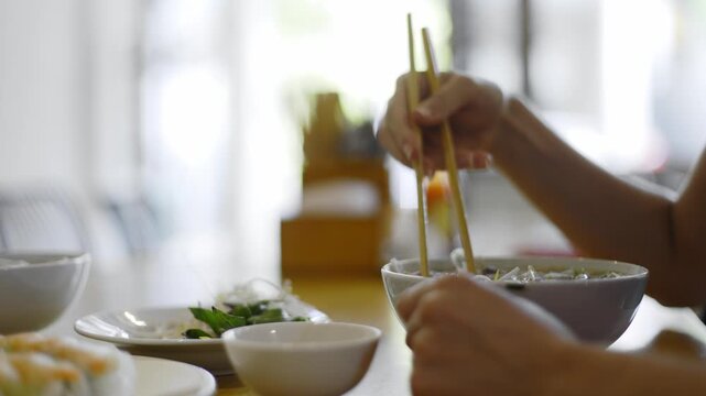 Dining ritual: chopstick skill and culinary delight in noodle meal preparation