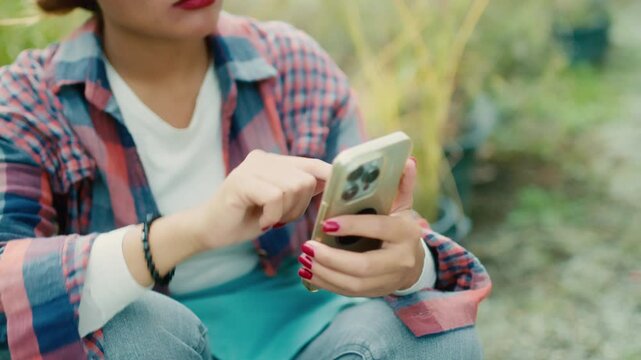 Young Woman Using Smart phone in Garden