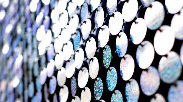 Colorful sequin wall shimmering in light as perspective shifts across patterned surface