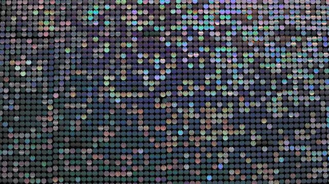 Sparkling sequin curtain with shimmering multicolor light reflections creating movement