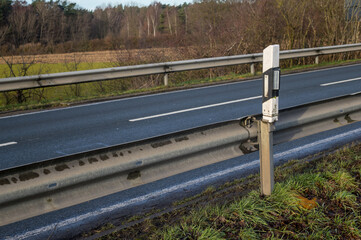 Fototapeta premium Road safety guardrail and delineation post on a rural road