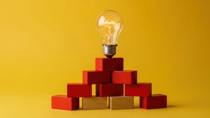 Pyramid of red blocks with illuminated light bulb on top