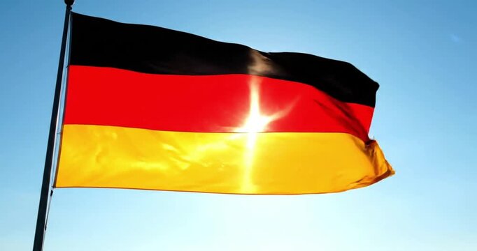 Germany National Symbol Fabric Blowing in Wind Against Blue Sky
