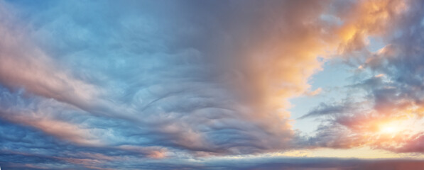 Lenticular cloudy sky panorama at the sunset.