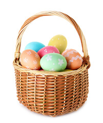 Painted Easter eggs in wicker basket isolated on white