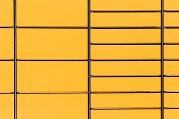 Yellow parcel locker wall. Automated parcel machine compartments. Modern self service delivery lockers. Urban logistics infrastructure background. Package pickup system for ecommerce shipping service