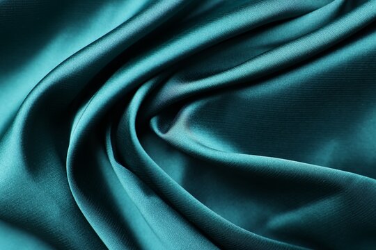 Beautiful green satin fabric as background, closeup view