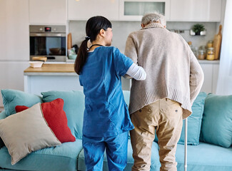 Doctor or nurse caregiver helping senior man walking  at home or nursing home