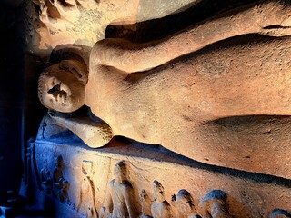Reclining Buddha in Cave 26 of the Ajanta Caves, ancient Buddhist rock-cut monument in India
