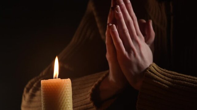 man prayer praying with burning candle. Religion concept