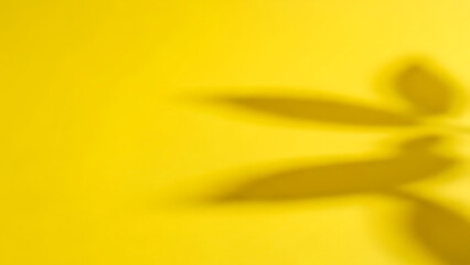 Vibrant yellow background with leaf shadow