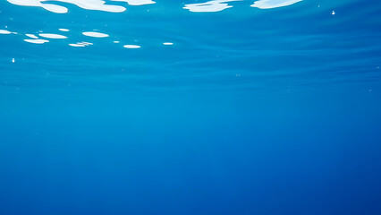 Serene underwater scene with sunlight filtering through ocean surface