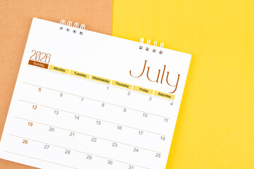 July 2026 desk calendar on brown and yellow, Planning for business.