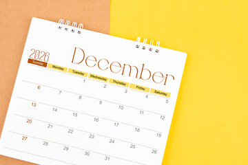 December 2026 desk calendar on brown and yellow, Planning for business.