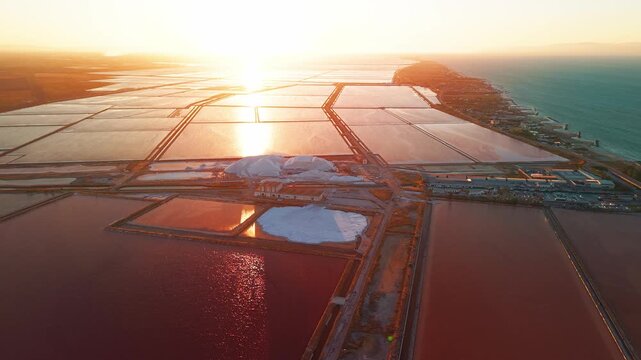 Aerial view of the Margherita di Savoia salt mines at sunset in Puglia, Italy
