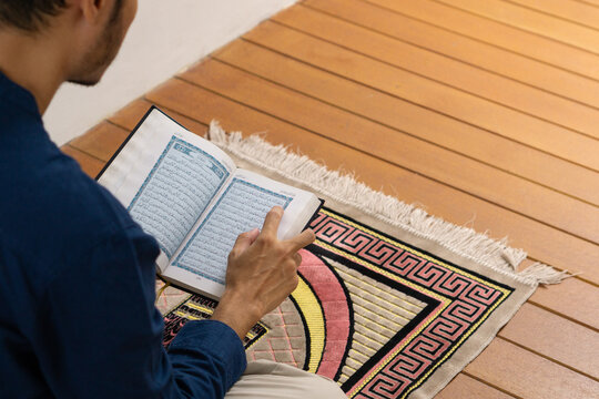 Muslim men is reading koran to worship