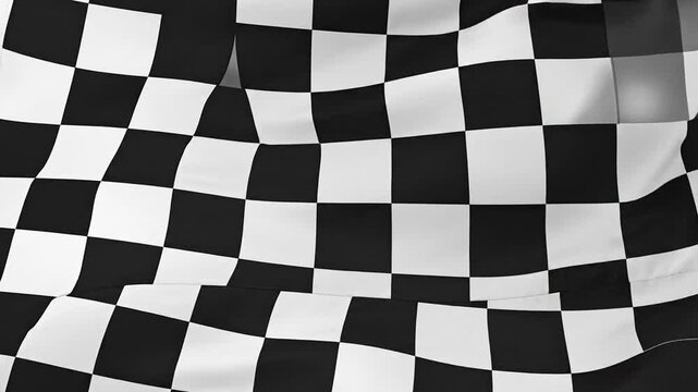 A close-up view of a waving checkered flag, with black and white squares. Light reflections visible
