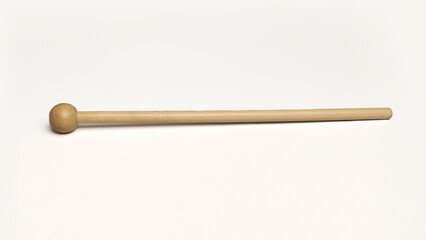 Single wooden percussion mallet with round ball tip isolated on white background for music concept