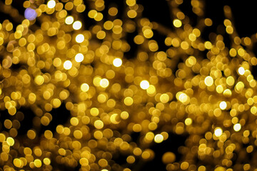 shiny golden circle bokeh on black for background.