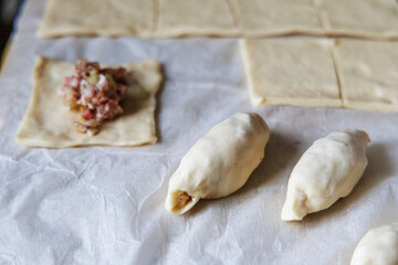 Making Homemade Meat Dumplings or Small Pies on Parchment