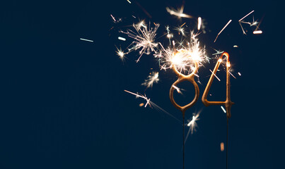 84 years anniversary celebration festive background made with Bengal fires in the form of number Eighty four.