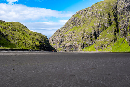 Saksun village and Waterfall - Faroe Islands. Black sandy beach