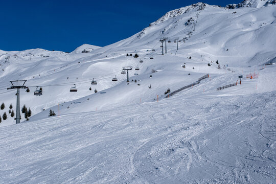 Ski slopes, skiers and beautiful winter landscape in Swiss Alps, Ski region Arosa-Lenzerheide