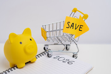Yellow piggy bank with save arrow next to shopping cart. Consumer savings concept. 