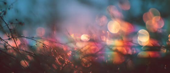Colorful light leak effect with rainbow bokeh and retro film grain overlay on dark background creative abstract style