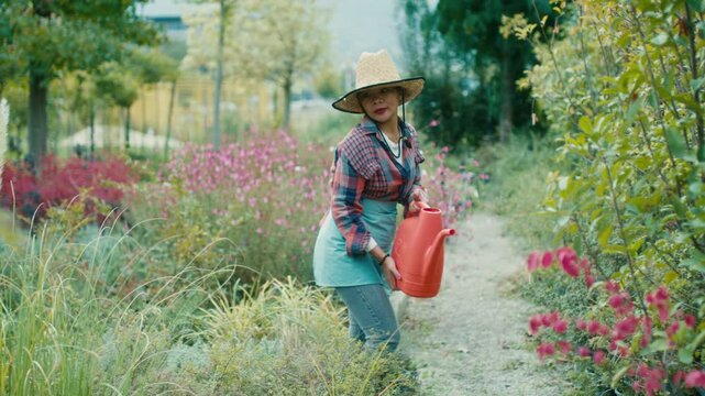 Woman watering plants in a vibrant garden