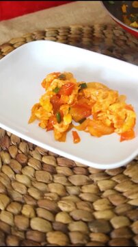 Professional Chef Serving Fresh Scrambled Eggs With Tomatoes On Plate