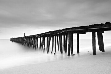 Scenery of wooden pier bridge at ban Thung pradoo in Thap Sakae Beach. Prachuap Khiri Khan, Thailand
