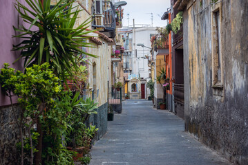 Fototapeta premium Via Valverde - street with chapel of Blessed Virgin Mary in Aci Castello town on Sicily Island, Italy