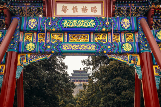 Traditional gate called paifang in front of Shouhuang Palace - view with Wanchun Pavilion in imperial Jingshan Park in Beijing, capital city of China
