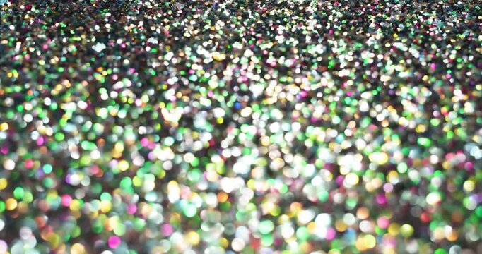 Colorful glitter confetti bokeh in stop-motion style with shimmering highlights and soft blur. Perfect for party, holiday, luxury, and festive abstract backgrounds.