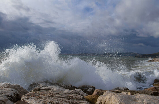 Beautiful seascape.Background of sea waves. Stormy sea waves.Dramatic sea waves crashing against coastal rocks against a cloudy sky.