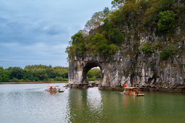 Tourist on boat close to the Elephant Trunk Hill. Taohua River, Xiangbishan, Guilin, China.