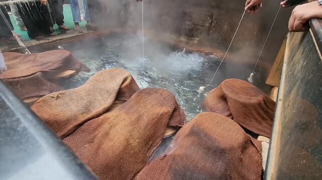 Gurudwara sahib manikaran with beautiful view of parvati river and walking people on bridge. Statue of Lord Shiva striking the ground with his trident over hot water gushing out of the ground.