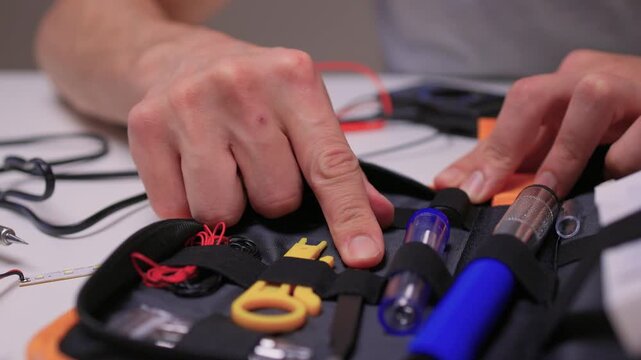 Skilled maker arranging components inside compact carrying case carefully, Professional working meticulously with specialized tools in well lit studio environment for repair tasks