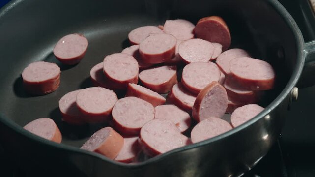Sliced Sausage Sizzling in a Frying Pan