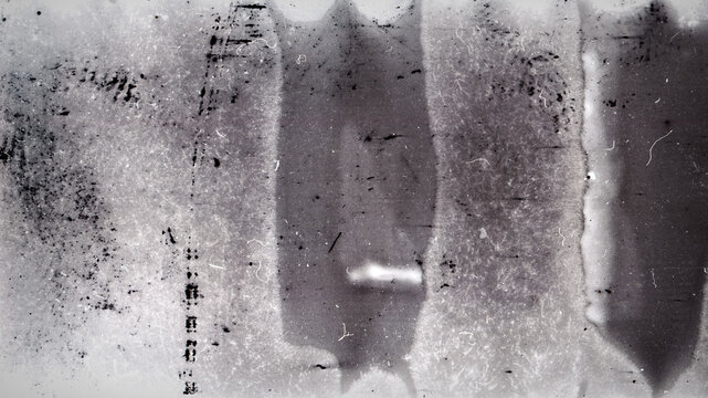Blank grained film strip texture background with heavy grain, dust and light leak. Old expired moldy photographic film scan.