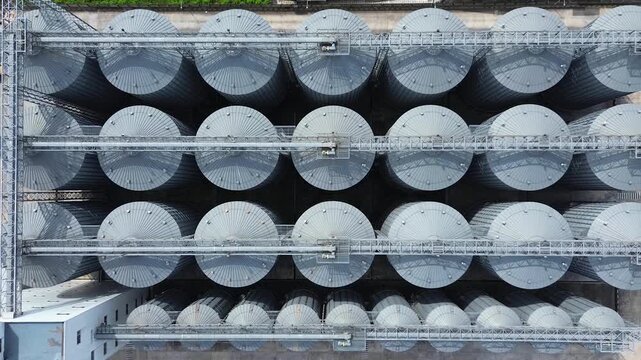 Rows of circular industrial storage tanks at a large manufacturing facility aerial